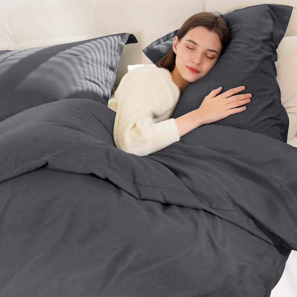 Gray reversible microfiber duvet cover set with two matching pillow shams on a neatly made bed